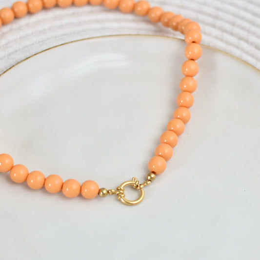 Kralen ketting met boeislot - pastel oranje