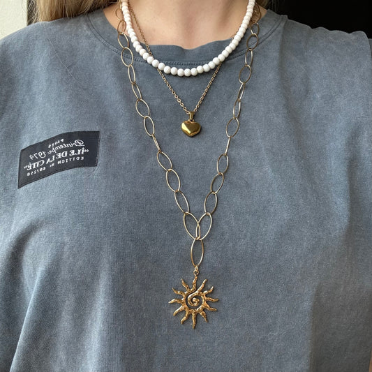 Lange ketting met zon bedel en grote ovale schakels - goudkleurig